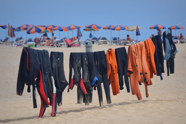 Alt Rash guards drying on a clothesline at the beach